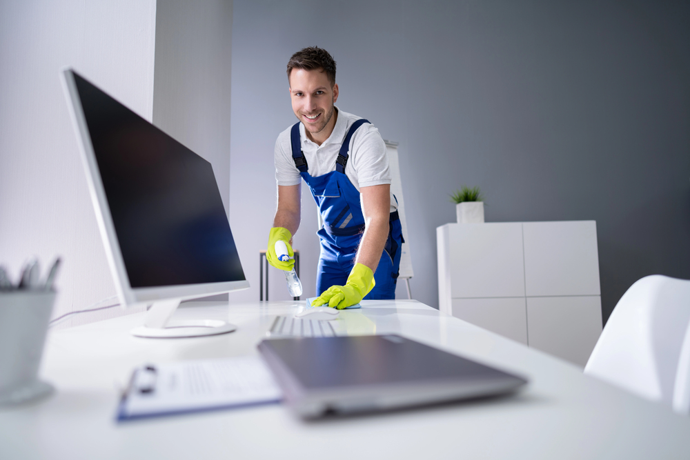 Professionelle Büroreinigung – Mitarbeiter reinigt professionell einen modernen Büroraum.